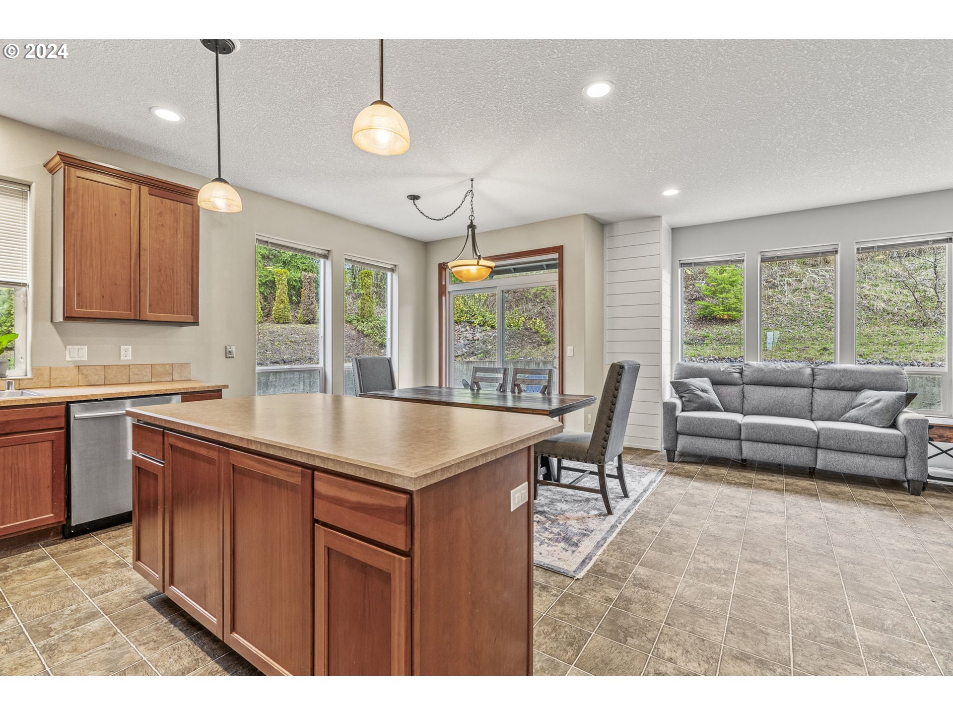 145 Ruby Court Kelso, WA 98626 - Photo 12 of 35 a open kitchen with stainless steel appliances granite countertop a sink a stove and a refrigerator with wooden floor