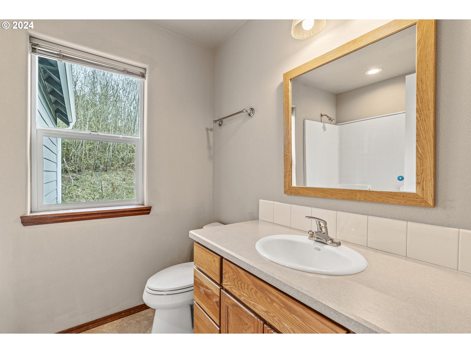 145 Ruby Court Kelso, WA 98626 - Photo 27 of 35 a bathroom with a granite countertop sink toilet and mirror
