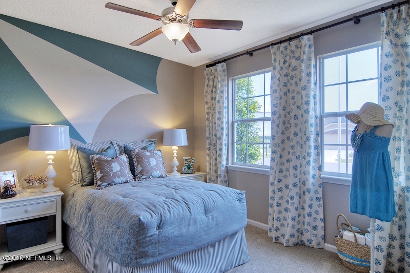 906 East Red House Branch Road St. Augustine, FL 32084 - Photo 12 of 13 a bedroom with a bed and a window