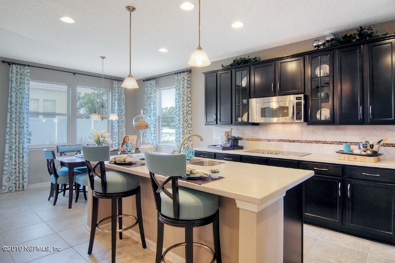 906 East Red House Branch Road St. Augustine, FL 32084 - Photo 5 of 13 a kitchen with granite countertop cabinets table and chairs