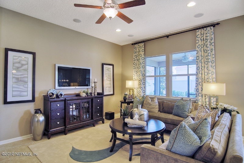 906 East Red House Branch Road St. Augustine, FL 32084 - Photo 9 of 13 a living room with furniture a flat screen tv and a large window