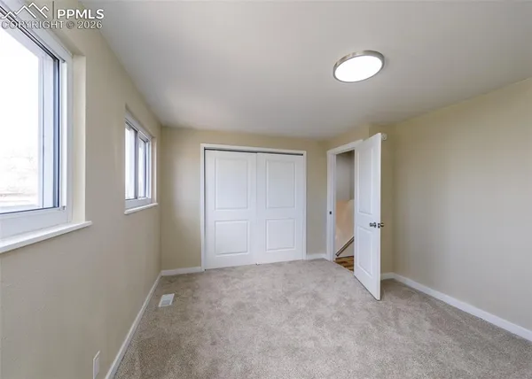 a view of an empty room with a window