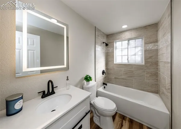 a bathroom with a sink mirror toilet and bathtub