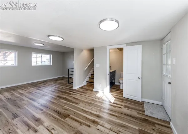 a view of a livingroom with wooden floor and window
