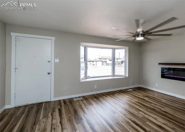 wooden floor in an empty room with a window