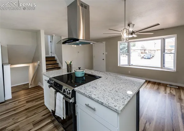 a kitchen with stainless steel appliances granite countertop a stove a sink and a refrigerator