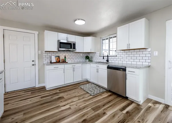 a kitchen with a sink cabinets and window