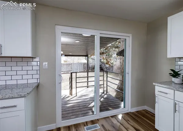 a view of a livingroom and wooden floor