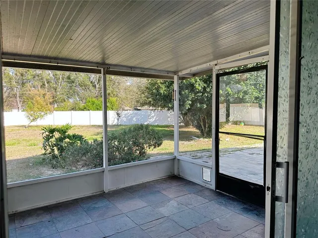 a view of an empty room with large windows