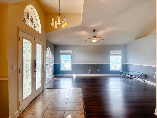 a view of a livingroom with furniture wooden floor and a chandelier