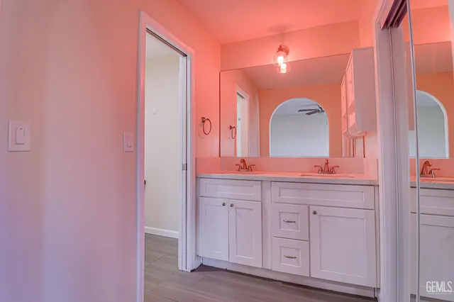 a spacious bathroom with a double vanity sink and a mirror