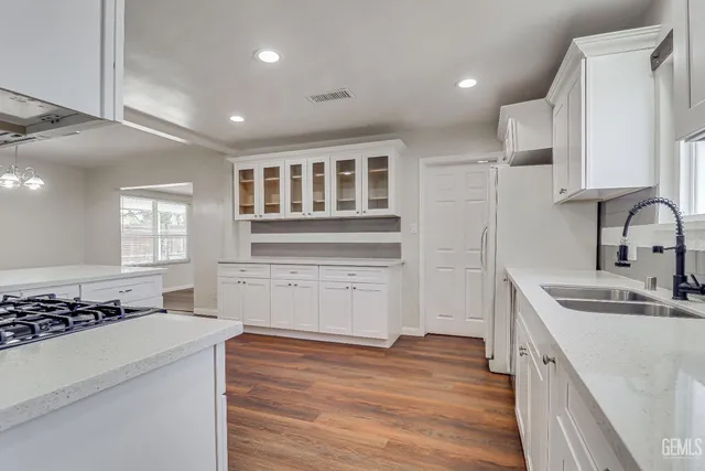 a kitchen with a sink stove and cabinets