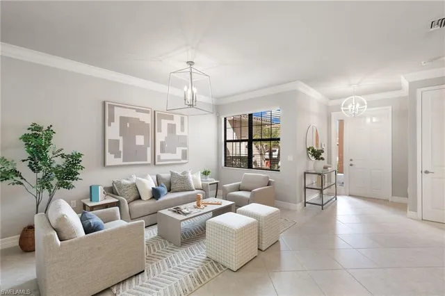 a living room with furniture and a chandelier