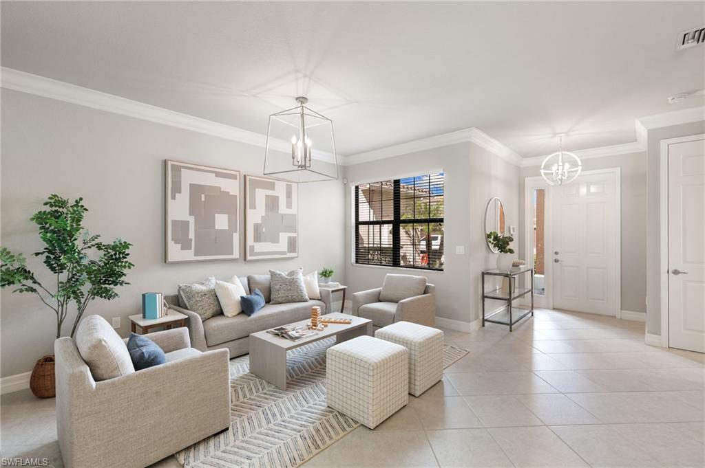 a living room with furniture and a chandelier