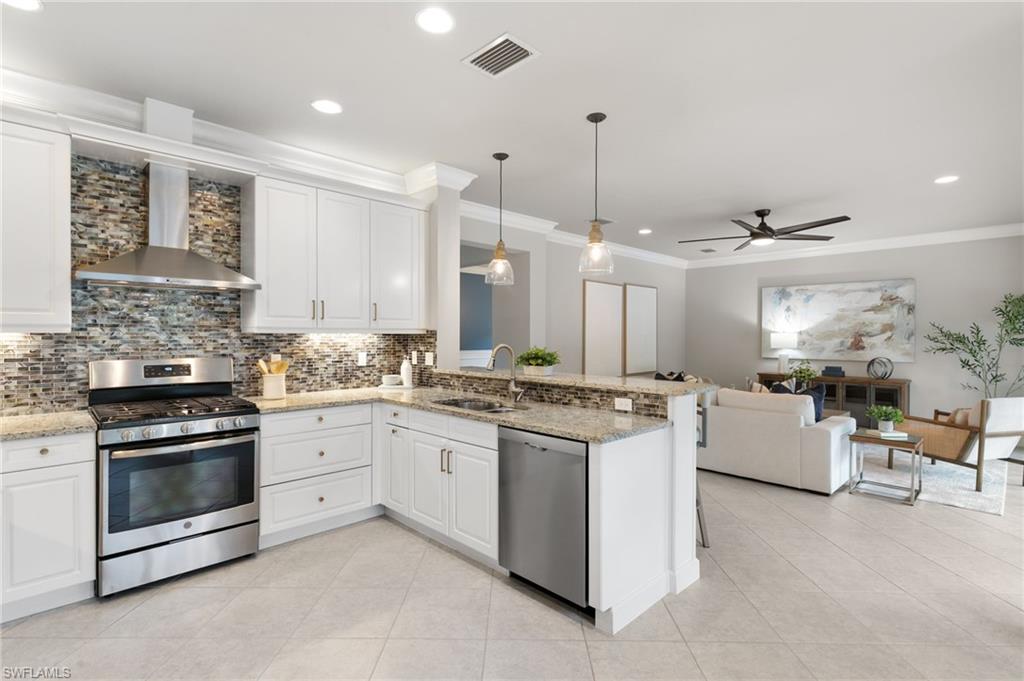 4384 Aurora Street Naples, FL 34119 - Photo 16 of 47 a kitchen with a stove and a sink