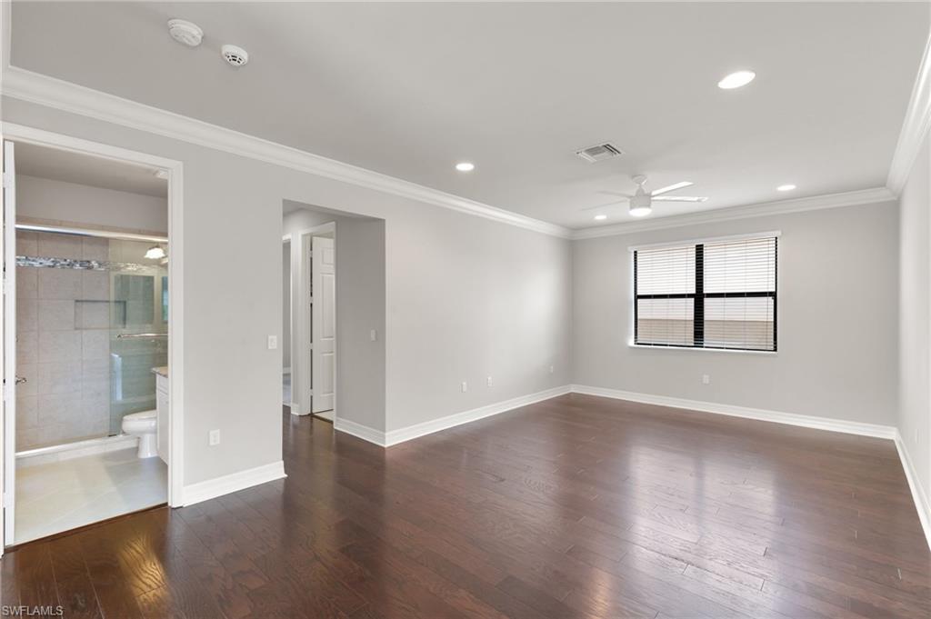 4384 Aurora Street Naples, FL 34119 - Photo 19 of 47 a view of an empty room with wooden floor and a window