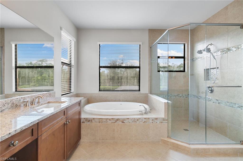 4384 Aurora Street Naples, FL 34119 - Photo 24 of 47 a bathroom with a granite countertop sink mirror and shower