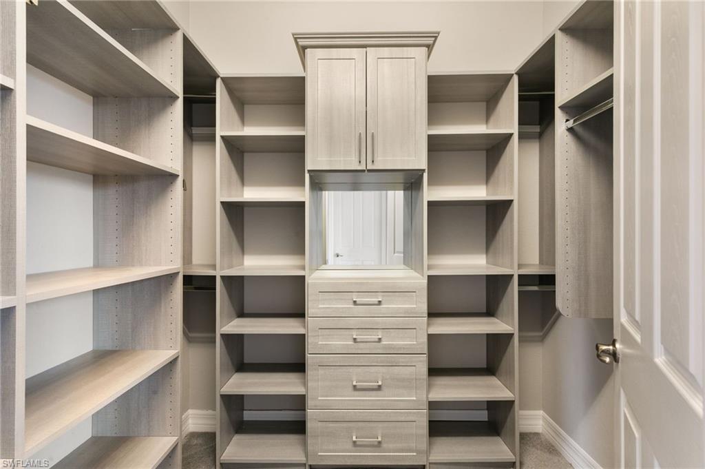 4384 Aurora Street Naples, FL 34119 - Photo 25 of 47 a view of walk in closet with empty racks