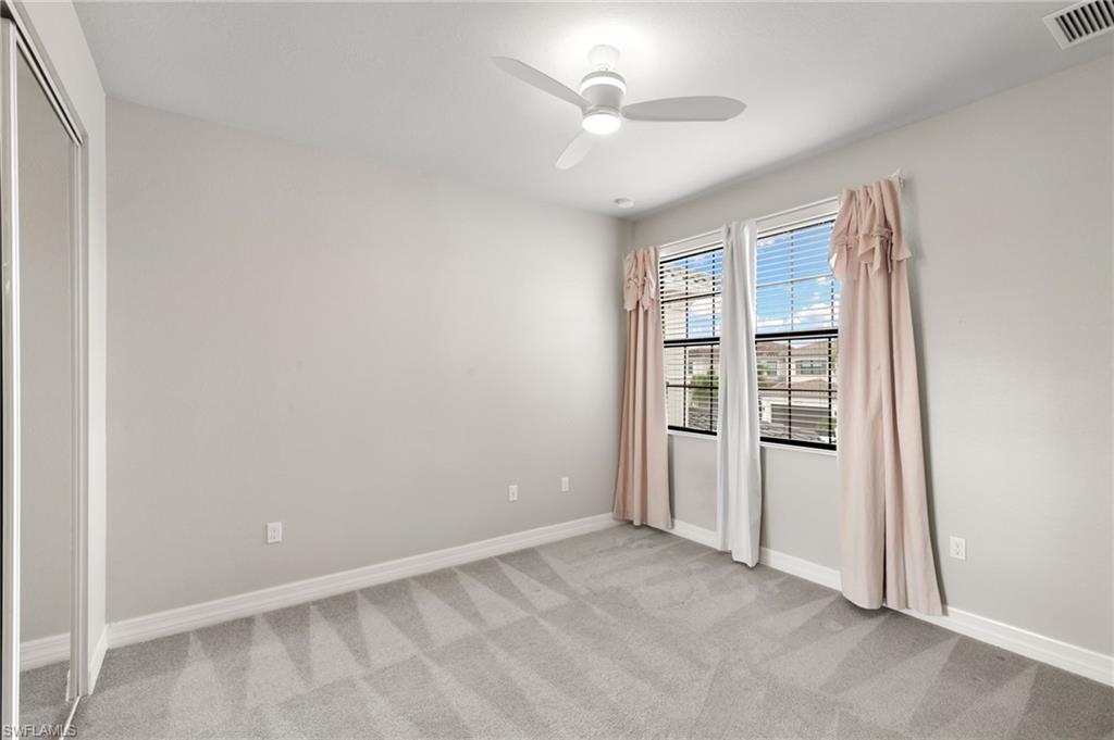 4384 Aurora Street Naples, FL 34119 - Photo 31 of 47 an empty room with windows and closet