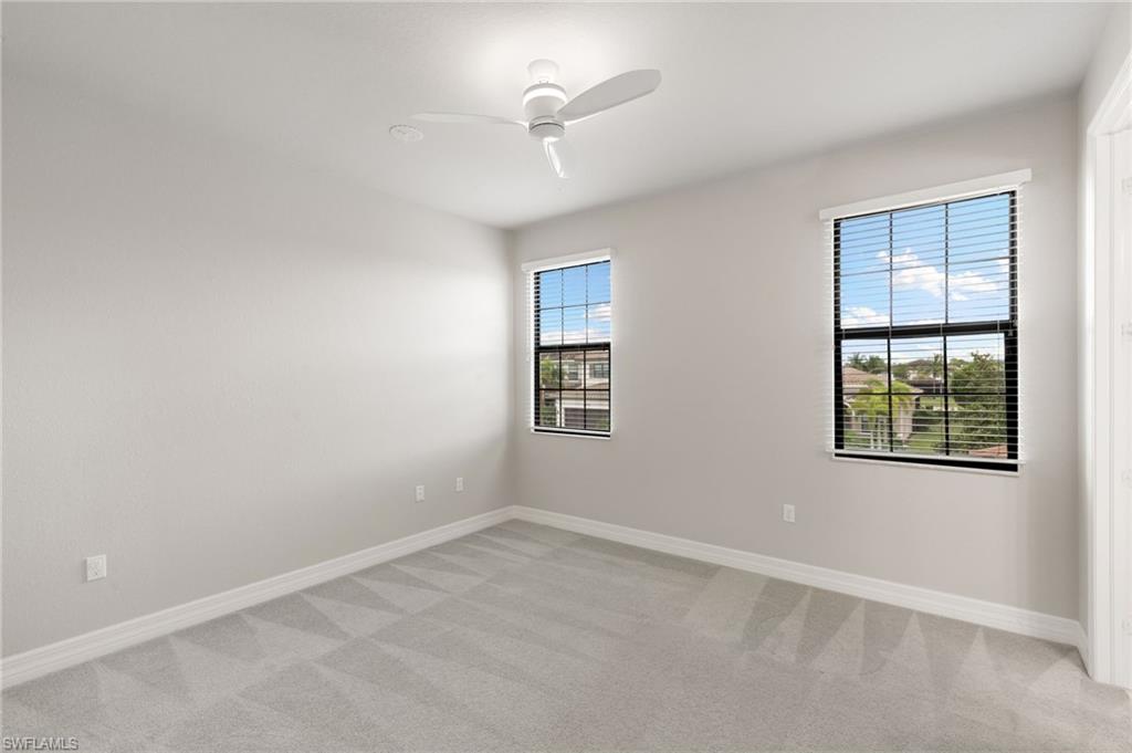 4384 Aurora Street Naples, FL 34119 - Photo 32 of 47 an empty room with windows and closet