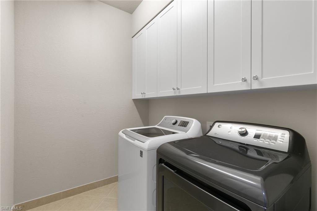 4384 Aurora Street Naples, FL 34119 - Photo 36 of 47 a utility room with dryer and washer