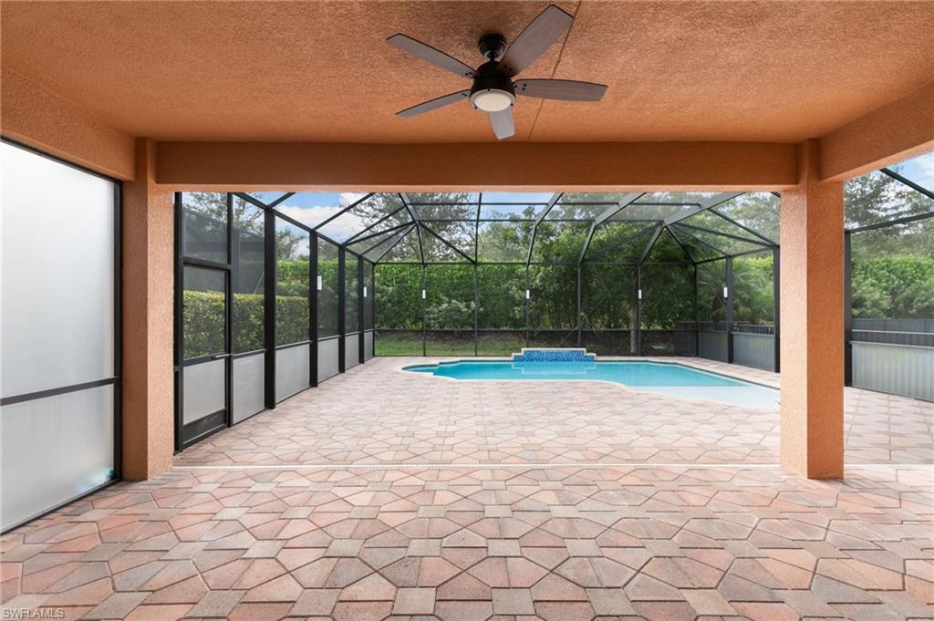 4384 Aurora Street Naples, FL 34119 - Photo 38 of 47 a view of a swimming pool with an outdoor seating