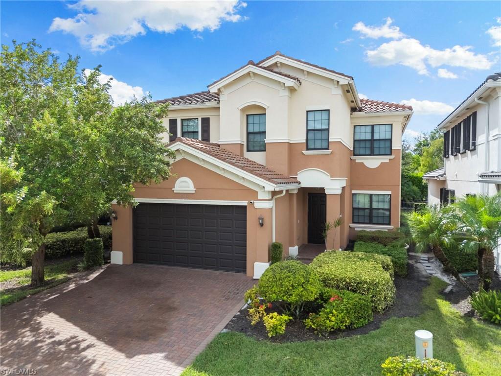 4384 Aurora Street Naples, FL 34119 - Photo 41 of 47 a front view of a house with a yard and garage