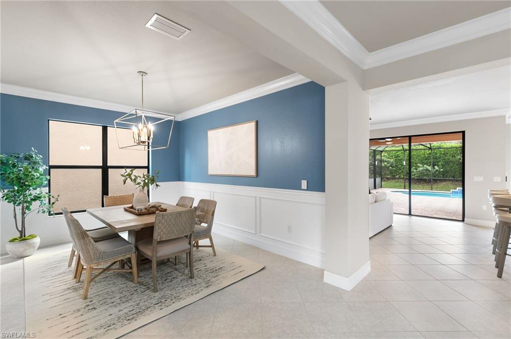 4384 Aurora Street Naples, FL 34119 - Photo 8 of 47 a dining room with furniture and window