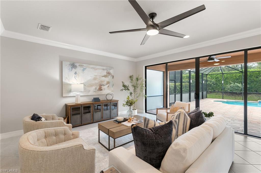 4384 Aurora Street Naples, FL 34119 - Photo 10 of 47 a living room with furniture and a large window