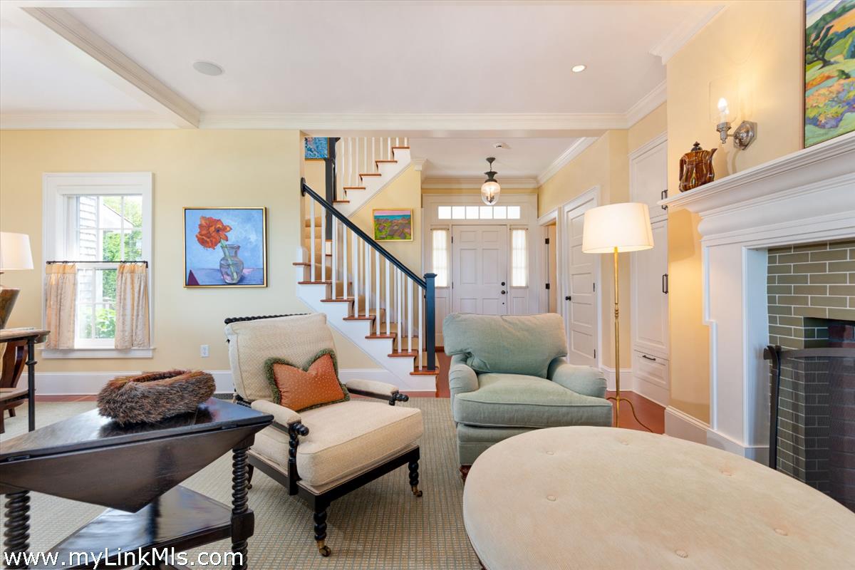 39 Cliff Road Nantucket, MA 02554 - Photo 7 of 46 a living room with furniture and a fireplace