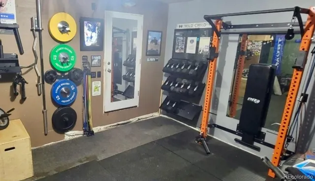 a view of entryway with a small yard and a refrigerator