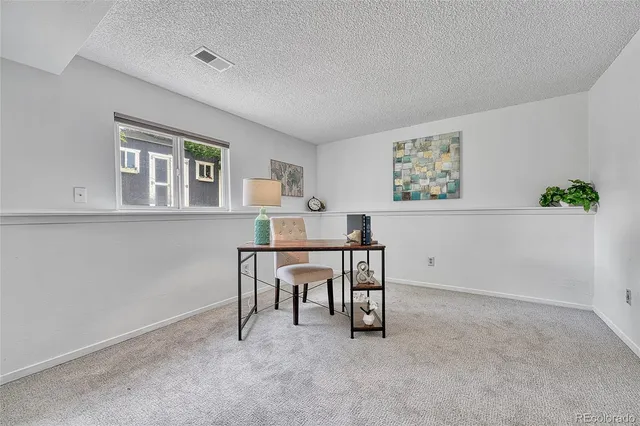 a view of a workspace with furniture and window in livingroom