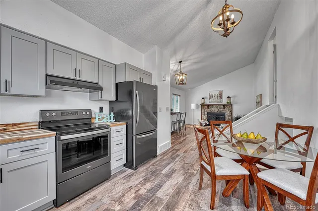 a kitchen with stainless steel appliances a stove a refrigerator and a refrigerator