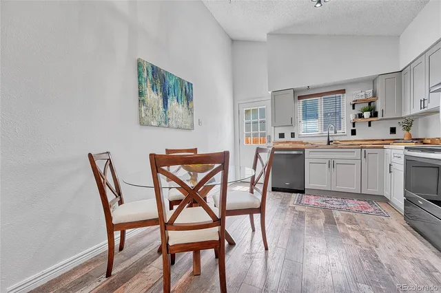 a view of a dining room with furniture and wooden floor