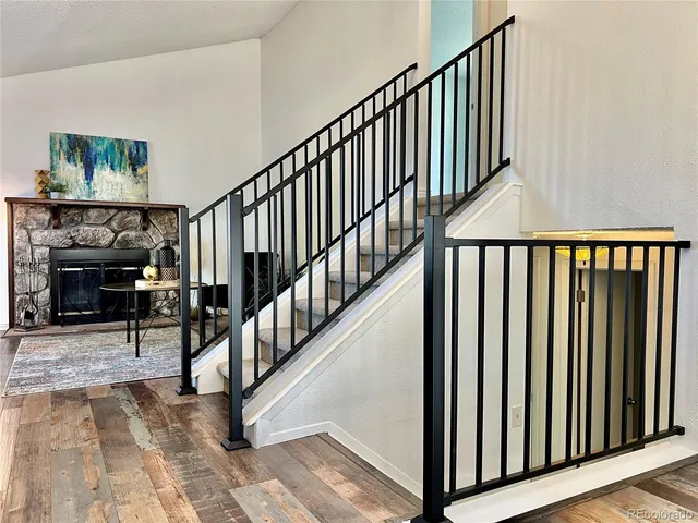 a view of staircase with railing and a rug