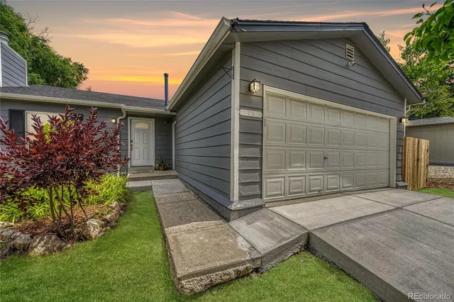 a front view of house with a garden