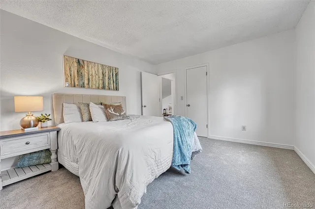 a bedroom with a bed and a night stand