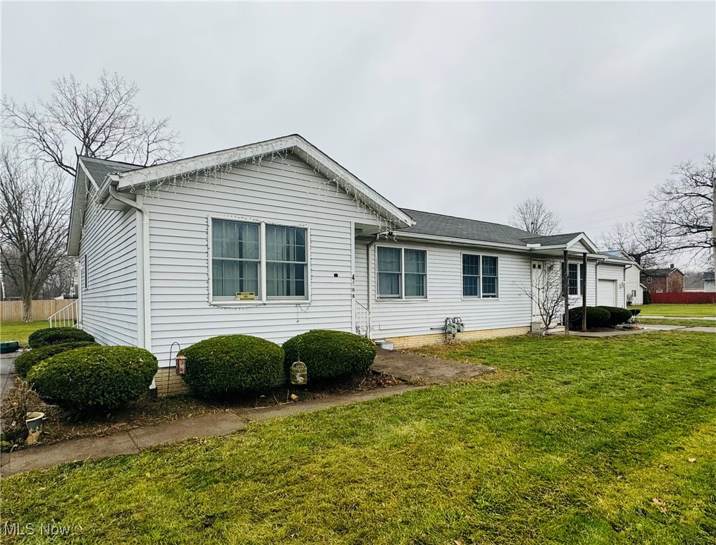 4400 Meister Road Lorain, OH 44053 - Photo 2 of 18 Ranch-style house featuring a front yard and a garage