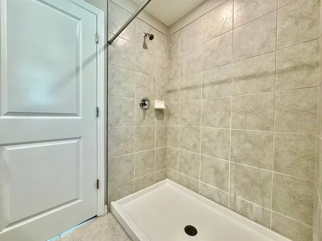 a bathroom with a tub and a shower