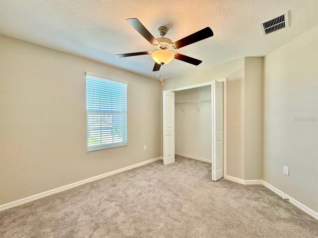 7020 Samuel Ivy Drive Tampa, FL 33619 - Photo 23 of 41 a view of an empty room with a ceiling fan