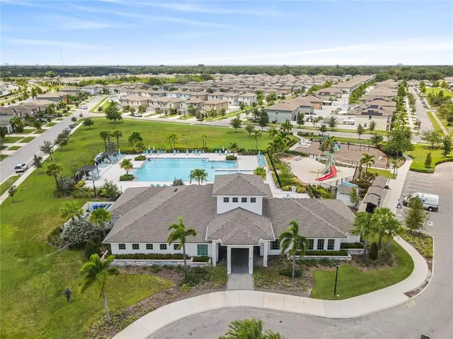 an aerial view of residential houses with outdoor space and river