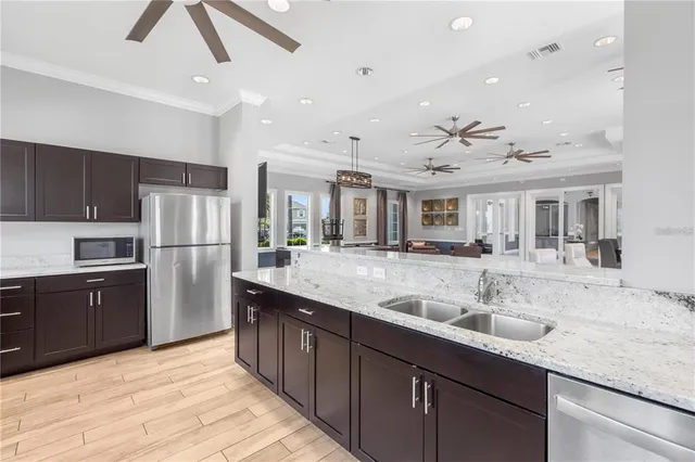 a large kitchen with kitchen island a sink stainless steel appliances and cabinets
