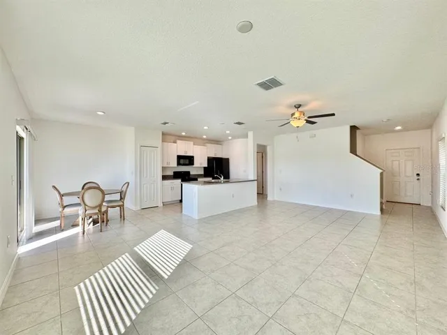 a living room with furniture and kitchen view