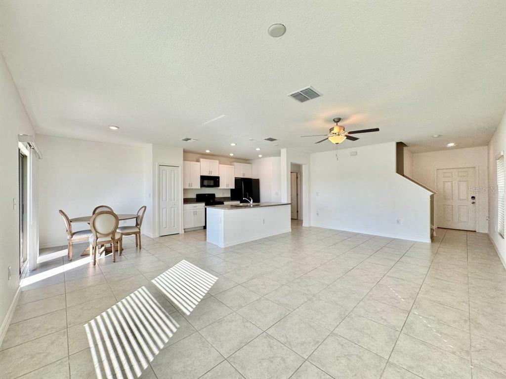 7020 Samuel Ivy Drive Tampa, FL 33619 - Photo 4 of 41 a living room with furniture and kitchen view