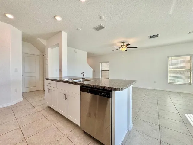 a kitchen with a sink and cabinets