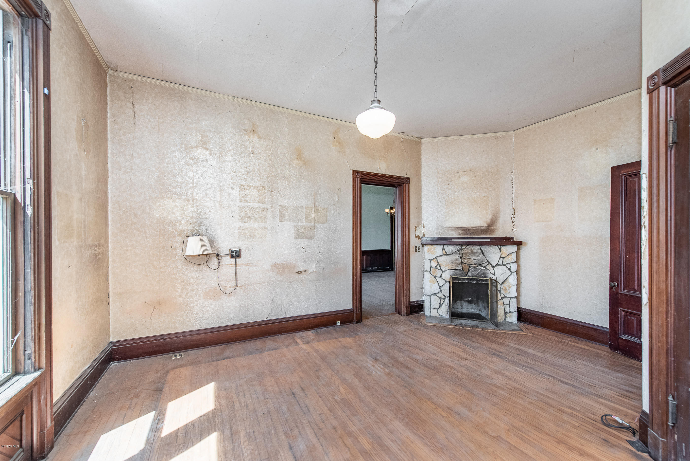 1226 Ojai Road Santa Paula, CA 93060 - Photo 16 of 73 a view of empty room with wooden floor and fireplace