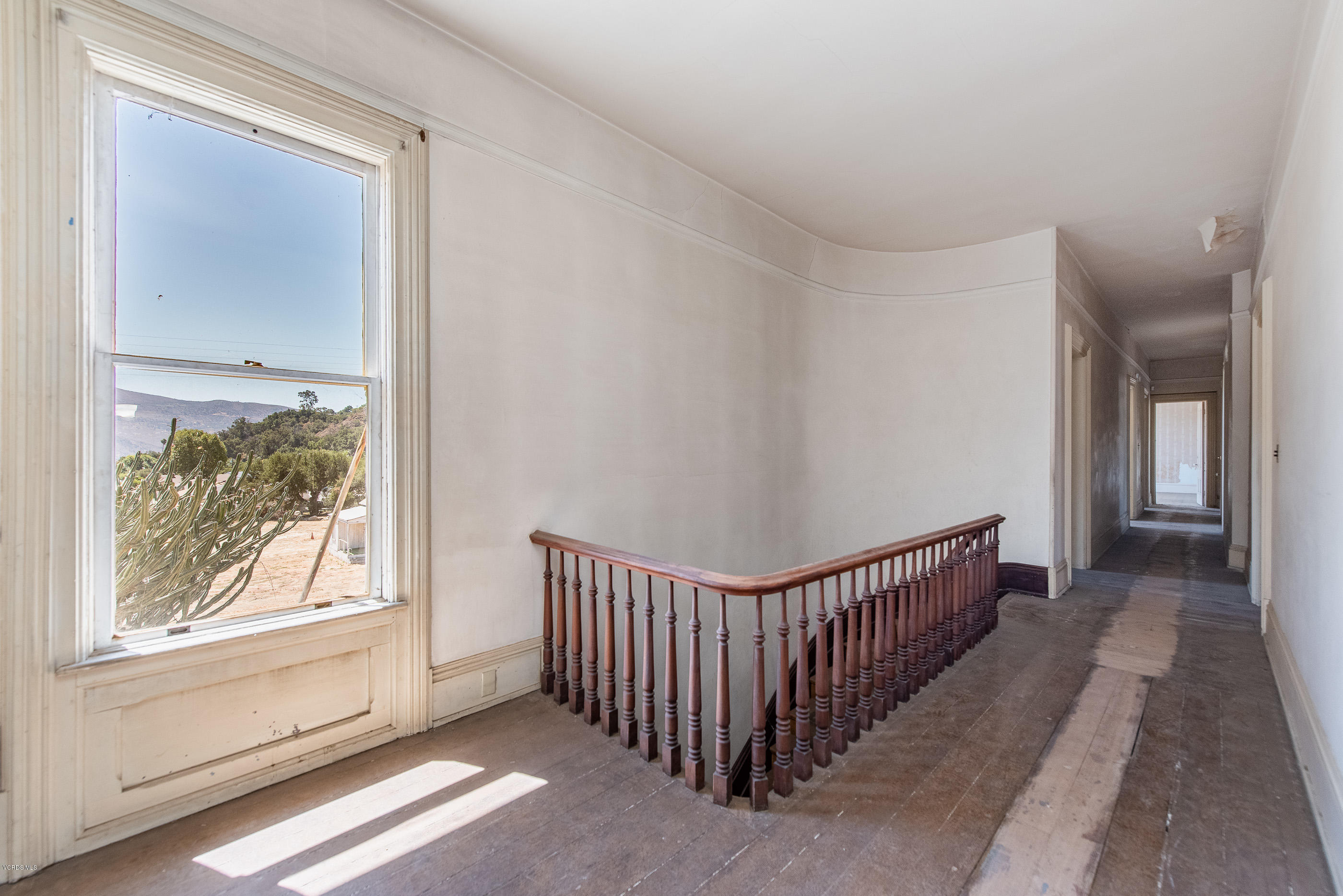 1226 Ojai Road Santa Paula, CA 93060 - Photo 29 of 73 a view of a hallway with wooden floor and windows