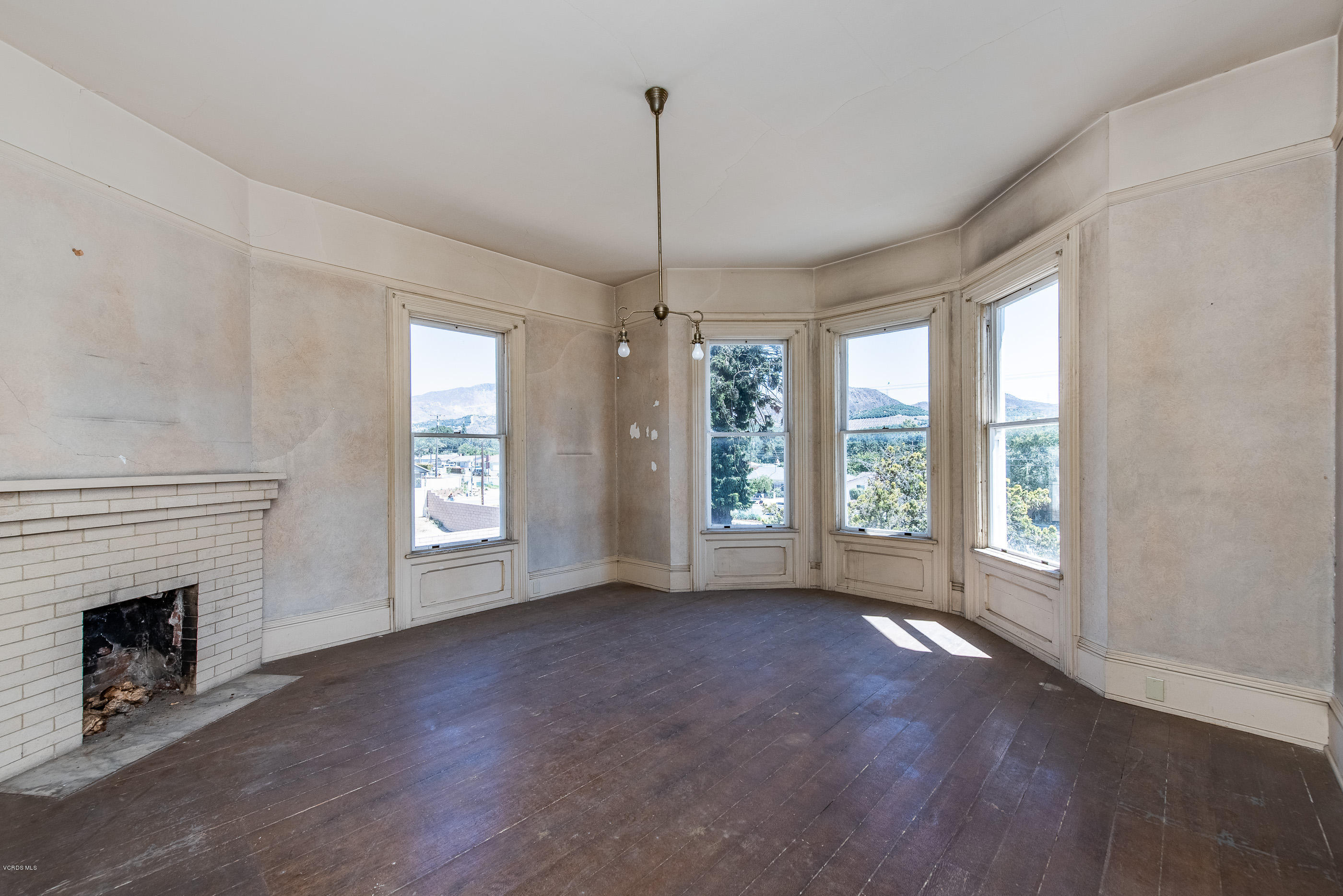 1226 Ojai Road Santa Paula, CA 93060 - Photo 7 of 73 a view of livingroom with window hardwood floor and fireplace