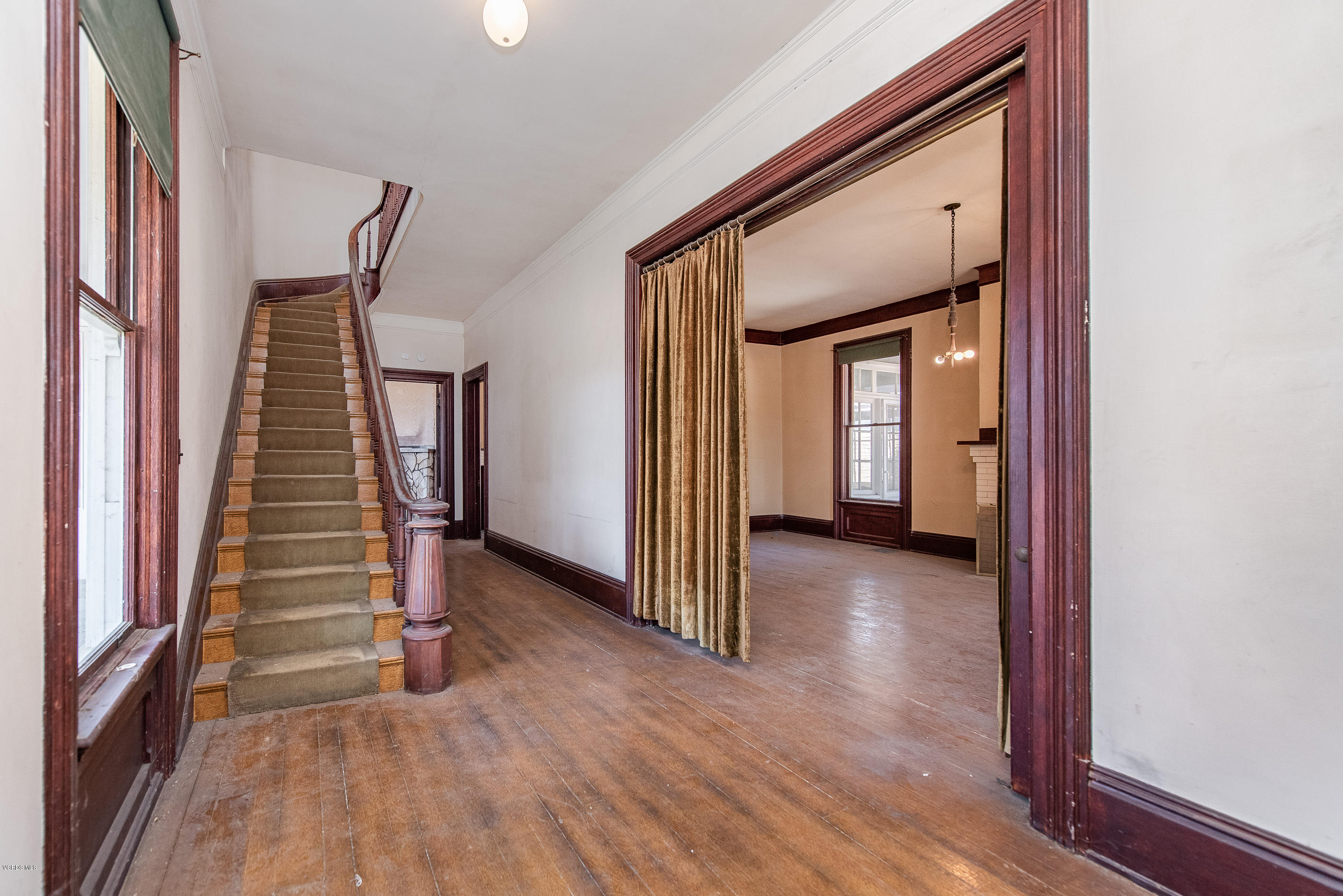 1226 Ojai Road Santa Paula, CA 93060 - Photo 9 of 73 a view of a hallway with wooden floor and staircase
