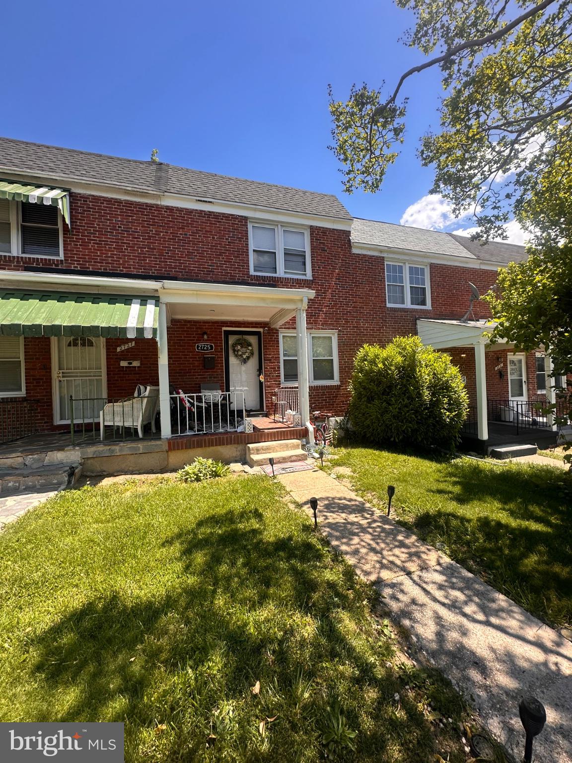 2725 North Rosedale Street Baltimore, MD 21216 - Photo 1 of 21 Charming brick home with lush greenery.